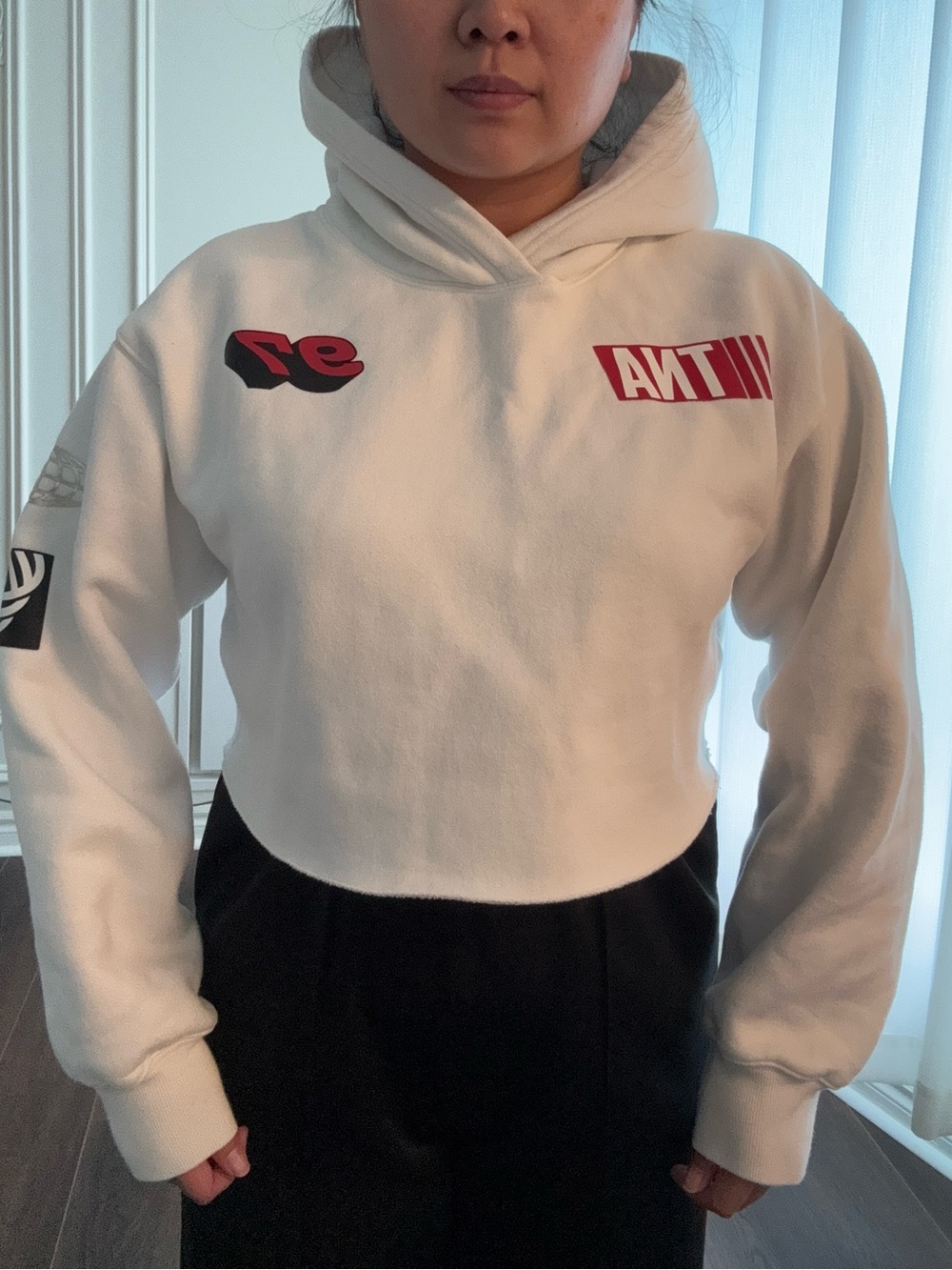 TNA White Cropped Hoodie Sweater with Red Graphic Accents